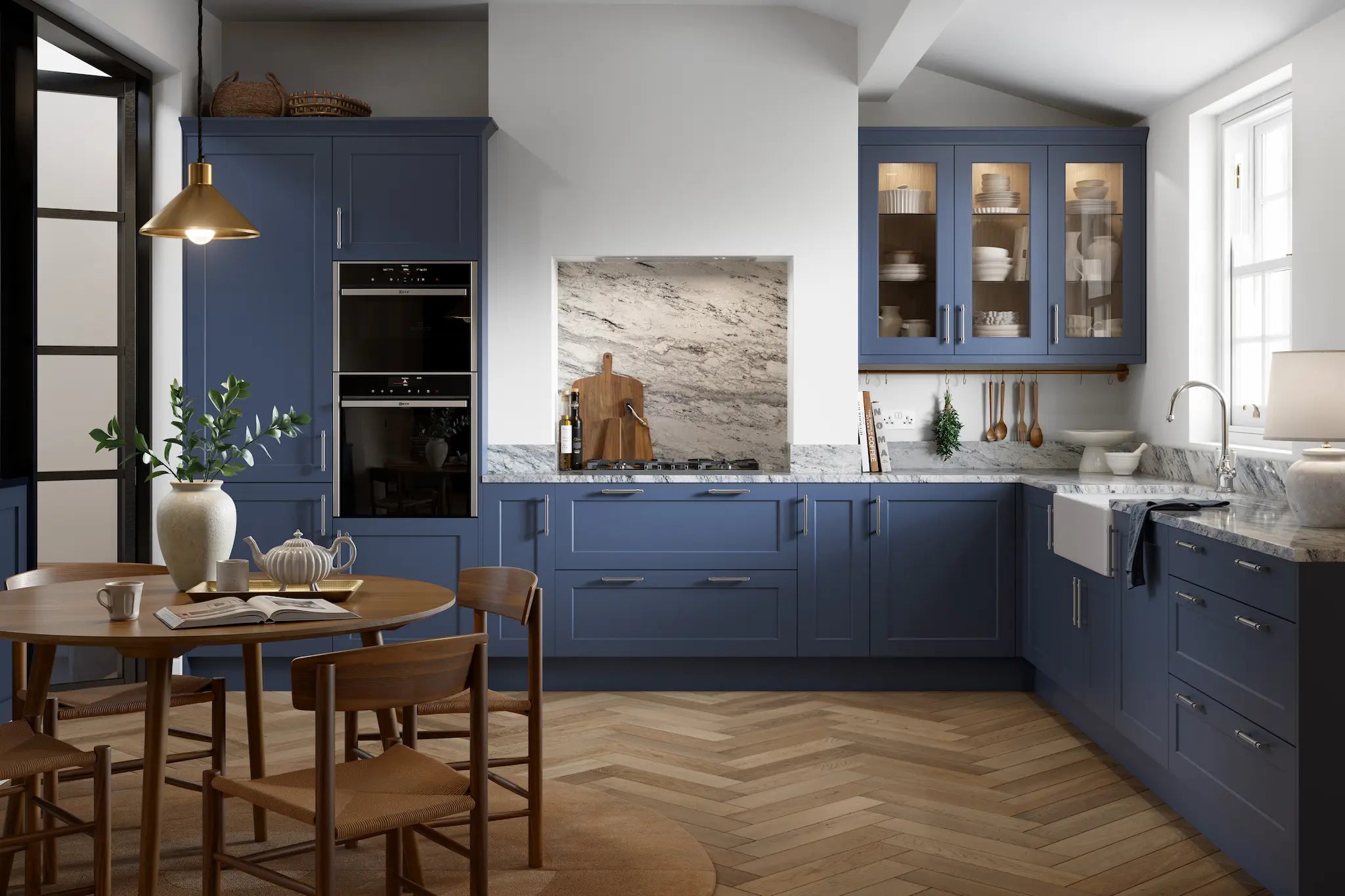 Bella Richmond paint flow matt colonial blue cabinets, wooden table, and chairs.