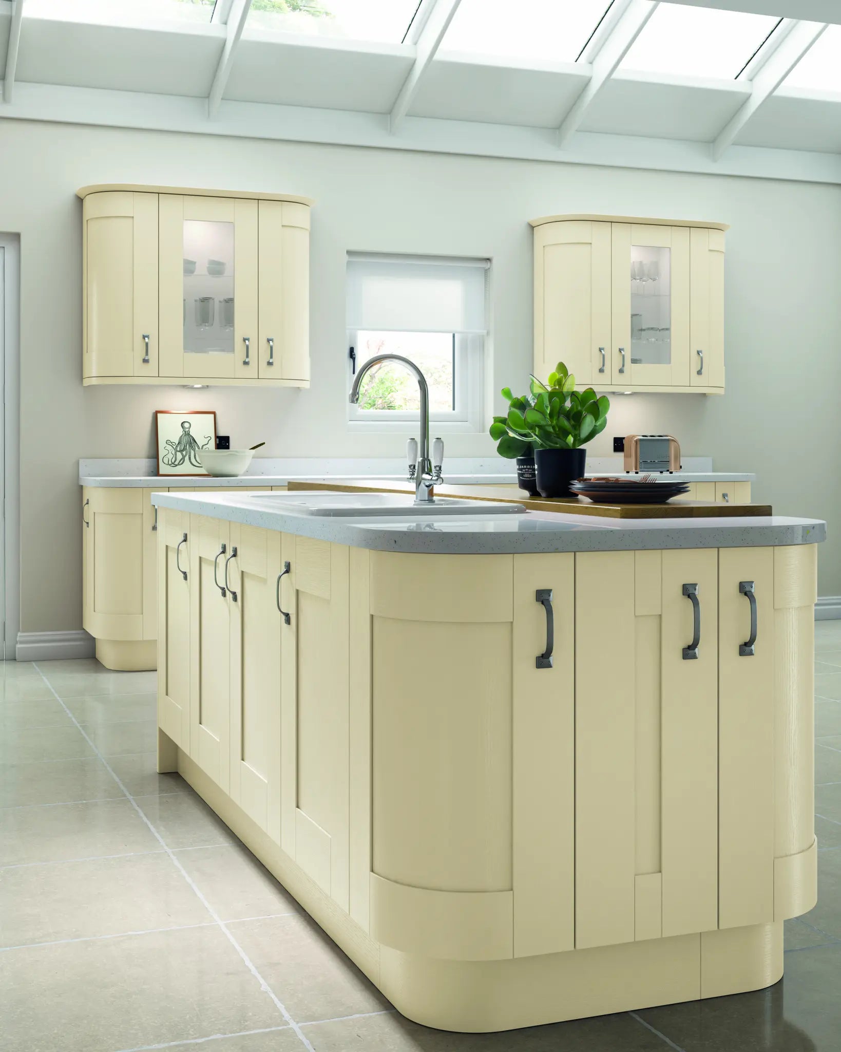Cartmel Mussel kitchen with a central island, cabinets, and a grey worktop.