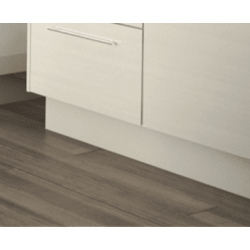 Close-up of a kitchen cabinet and plinth with a wooden floor.