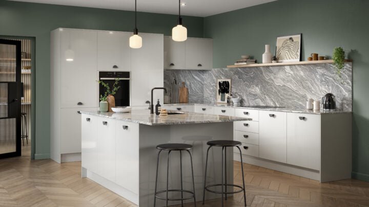 Ora kitchen with light grey cabinets, marble countertop, and gray backsplash.