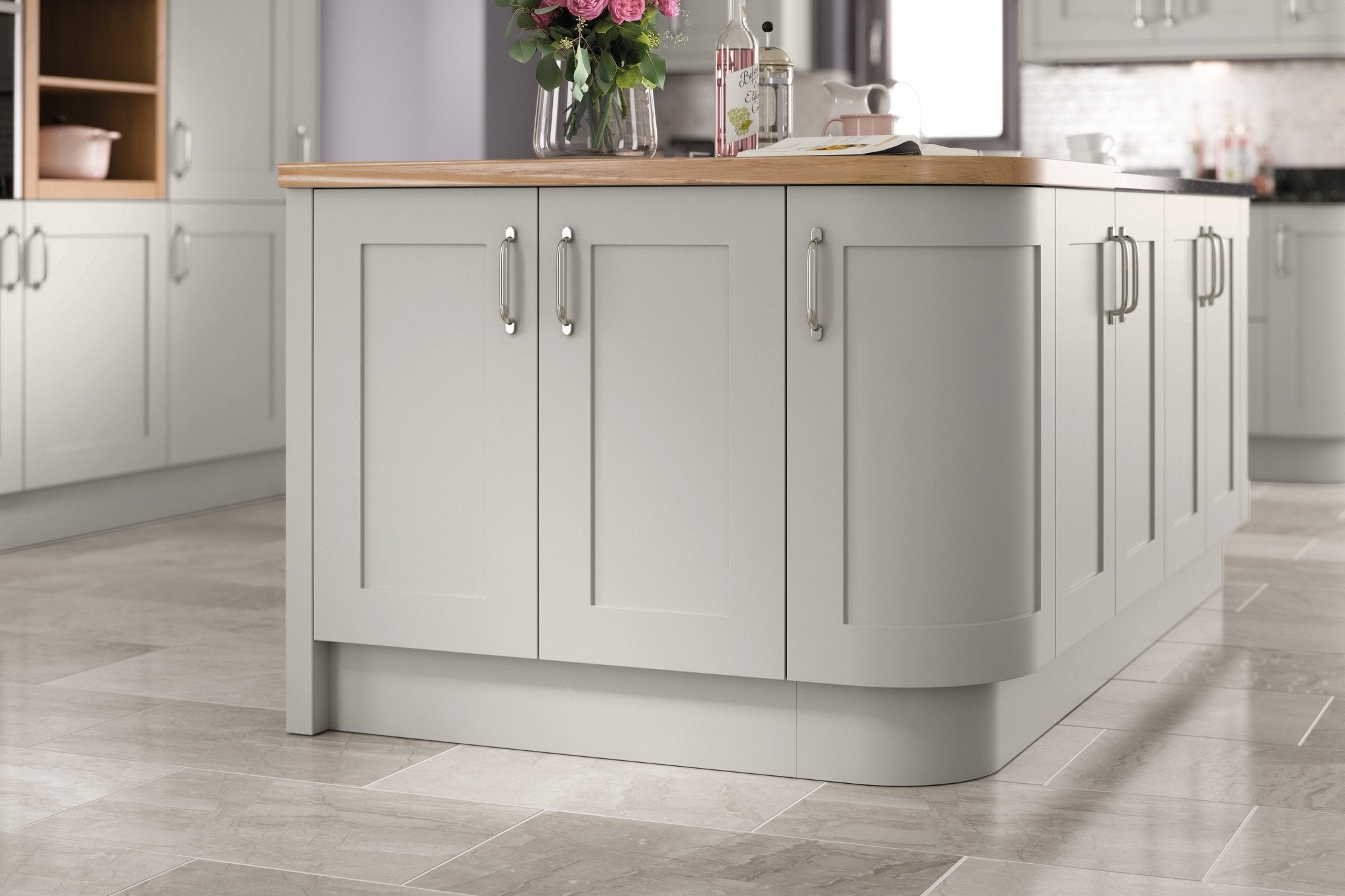 Grey kitchen island with wooden countertop in a modern kitchen setting