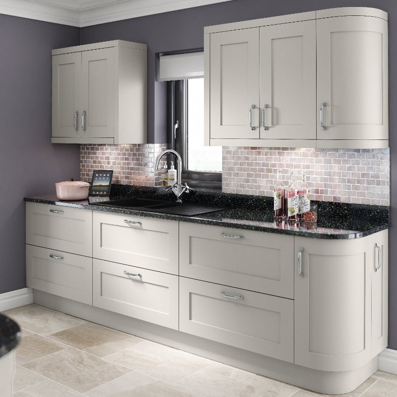 Modern kitchen with grey cabinets, black countertop, and tiled backsplash.