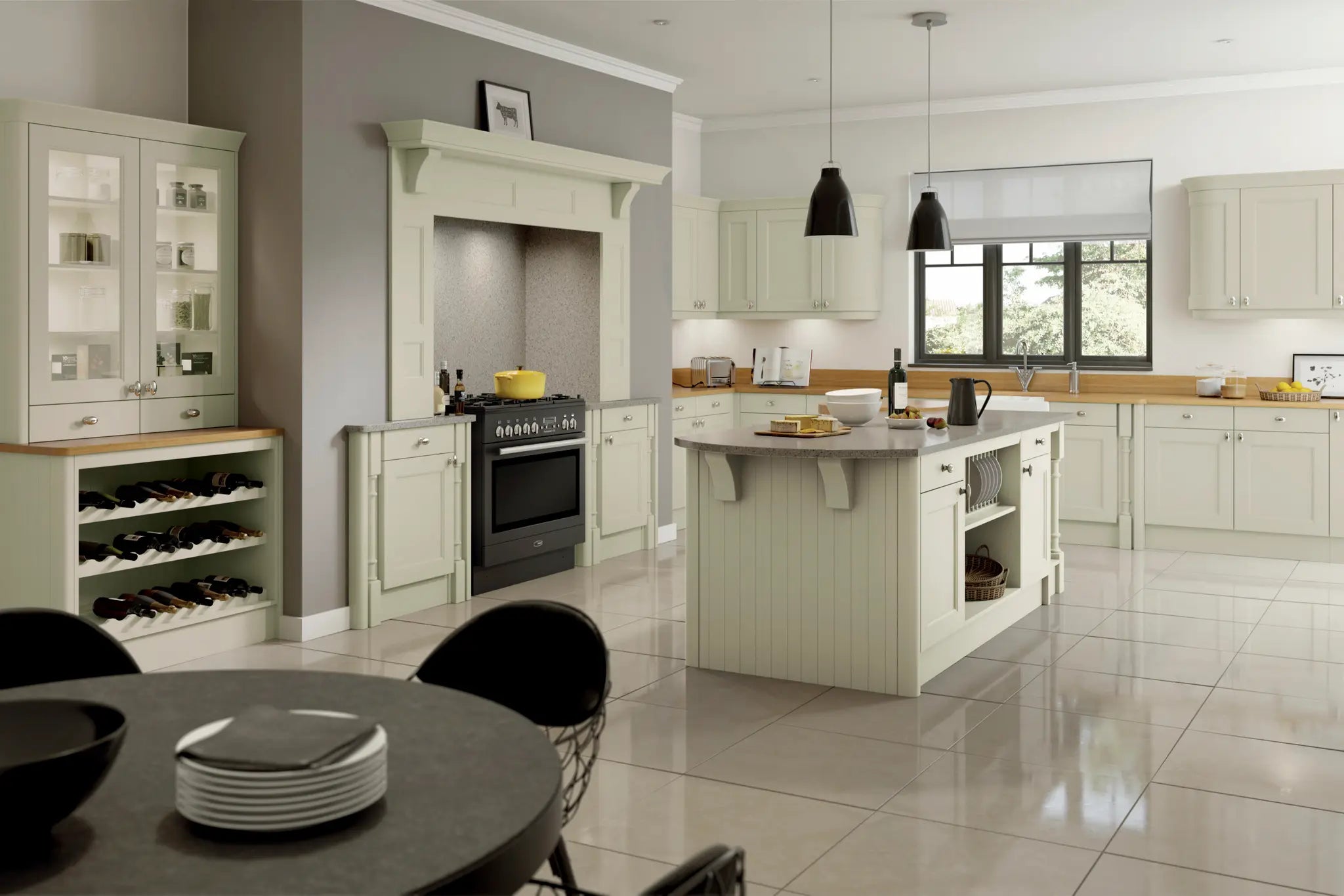 Traditional shaker kitchen with painted sage green cabinets, black range cooker with mantel kit, an island, and a dining table.
