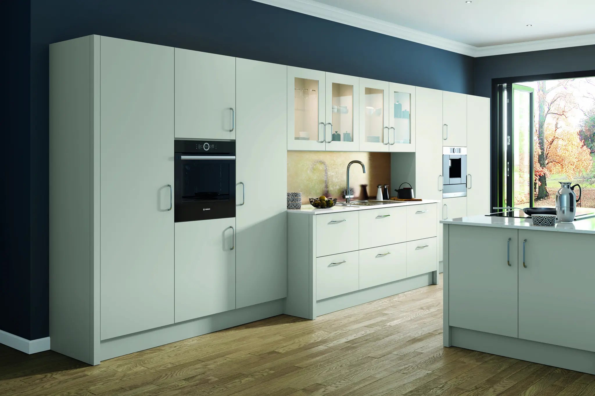 Modern Vivo slab-style kitchen with light grey cabinets, black appliances, and a large window. Features glazed doors and plinth.
