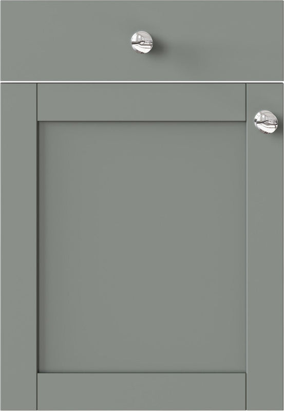 Green cabinet door with silver knobs on a white background