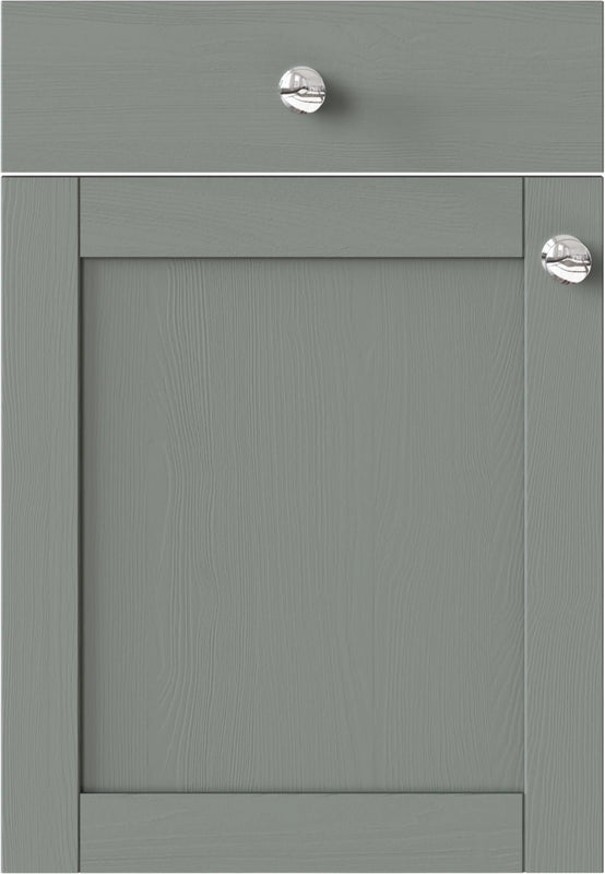 Waterford Sage Green kitchen cabinet door with two silver knobs.