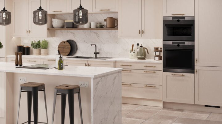 Supermatt Cashmere Waterford kitchen with white marble island, black appliances, and wooden stools.