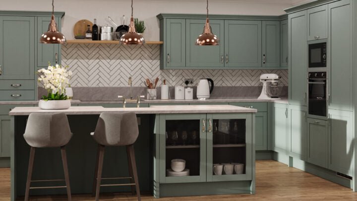 Waterford kitchen with sage green cabinets, marble island, and stainless steel appliances.