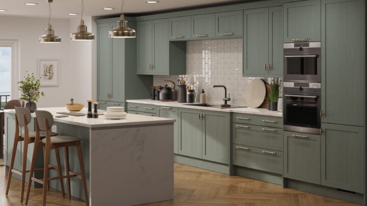 Modern kitchen with green cabinets, marble island, and stainless steel appliances.