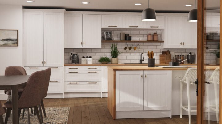 Modern kitchen with white cabinets, wooden countertops, and a dining area.