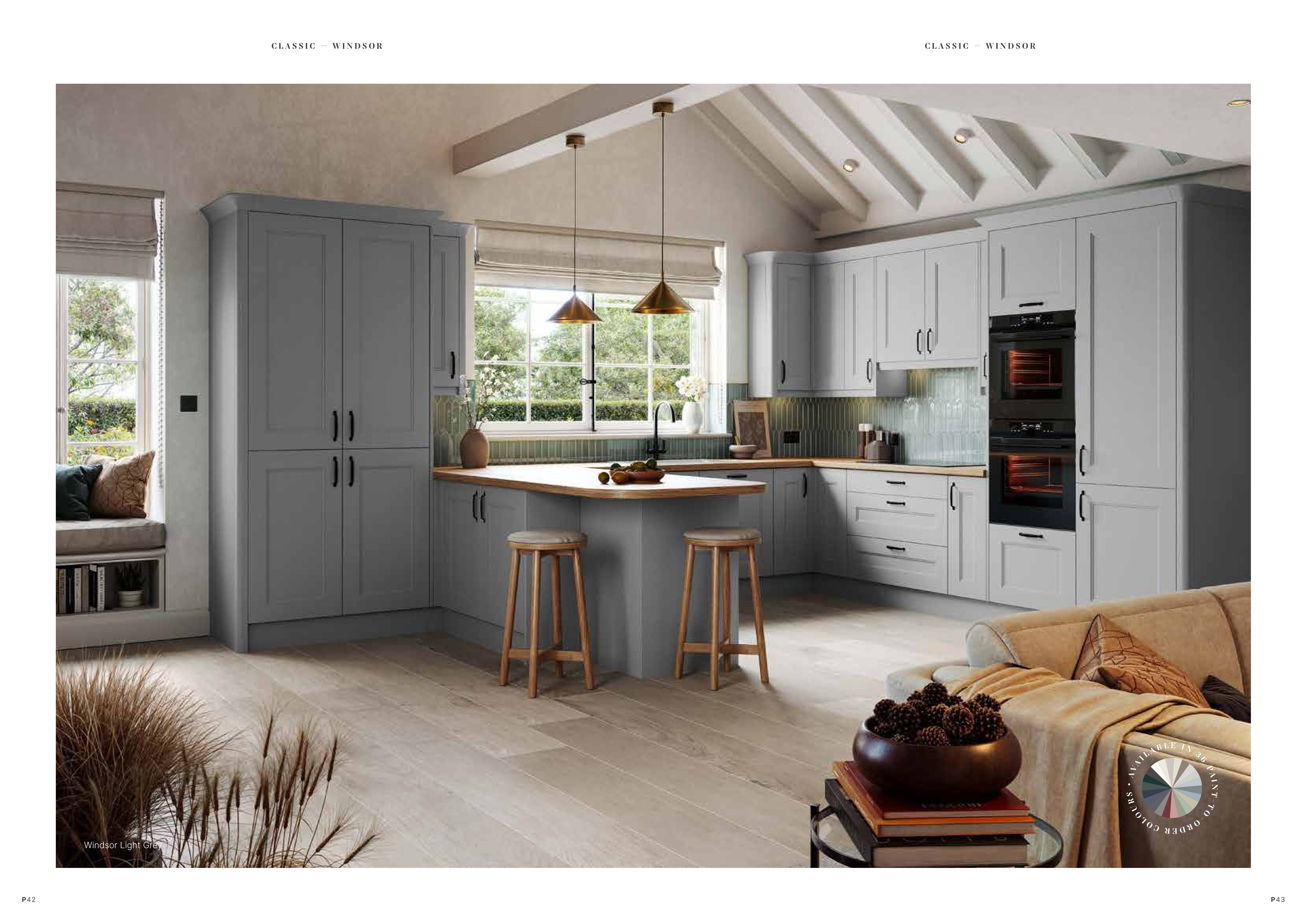 Modern kitchen with gray cabinets, island, and bar stools.