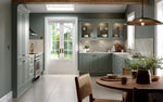 Bella Carlton Matt Sage Green kitchen featuring glazed wall unit doors and a tangent cornice.