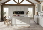Modern kitchen with light grey cabinetry, island, and wooden flooring.