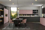 Modern kitchen with pink and black cabinets, dining table, and chairs.