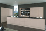 Modern slab kitchen with cashmere cabinets and black countertops