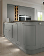 Dust Grey Cambridge shaker kitchen focussing on a curved door.