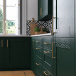 Cambridge kitchen with fir green cabinet doors and gold handles.