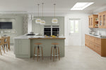 Modern kitchen with wooden cabinets, island, and stools.