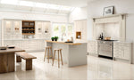 Modern kitchen with cashmere cabinets, wooden island, and stainless steel appliances.