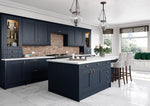 Modern Cartmel kitchen with indigo cabinet doors, white countertops, and marble flooring.
