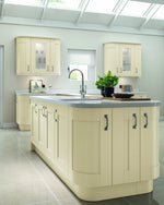 Cartmel Mussel kitchen with a central island, cabinets, and a grey worktop.