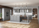 Modern kitchen with grey island, wooden floor, and white walls