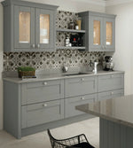 Dust grey Cambridge shaker kitchen featuring a tangent cornice and four glazed doors.