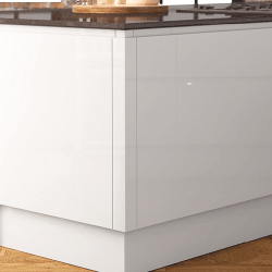 Close-up of a Jayline white kitchen cabinet with a wooden floor and countertop in the background.