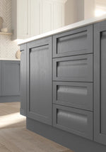 Dust Grey kitchen doors and drawer fronts from the Grantham range highlighting the wooden grain and the handleless grip.