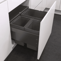 Gray kitchen drawer with pull out bins inside a white cabinet.