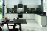 Modern Lucente kitchen in Matt Light Grey with black countertops, and a dining table.