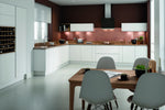 Modern Lucente kitchen with white cabinets and doors, wooden countertops, and grey chairs.