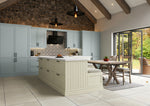Modern kitchen with stone wall, island, and dining area