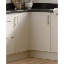 White kitchen cabinets with black countertop and basket on a shelf.
