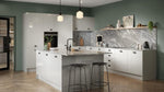 Ora kitchen with light grey cabinets, marble countertop, and gray backsplash.