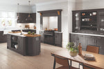 Oxford anthracite kitchen with black island and cabinets, wooden dining table, and white walls. A full mantel kit is around a range.