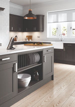 Oxford kitchen with anthracite doors and cabinets, white countertops, and wooden flooring. A plate-rack is prominent.