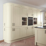 Modern kitchen with Oxford Ivory doors and black granite worktop. Featuring curved doors, cornice and plinth.
