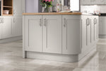 Grey kitchen island with wooden countertop in a modern kitchen setting