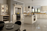 Modern kitchen with off white cabinets, black range cooker, and a dining table.