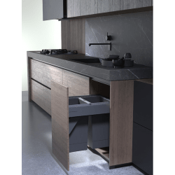 Modern kitchen with dark wood cabinets, pull out bin and a grey backsplash.