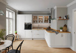 Modern Stratto kitchen with white cabinets, wooden countertops, and stainless steel appliances. Features glazed doors on three wall units, and a curved base door.