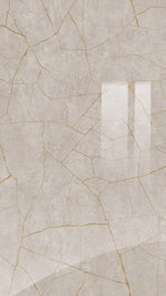 Beige ceramic tile with gold accents on a textured background