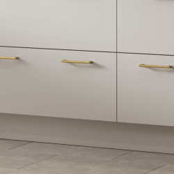 Valore Snow White kitchen cabinets with gold handles on a light gray floor.