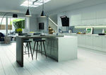 Modern Vivo kitchen with light grey gloss doors and island, stools, and a view of a living area.
