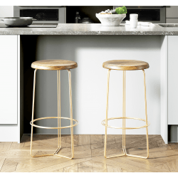 Two wooden stools with gold metal legs on a kitchen floor.