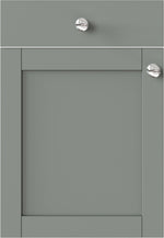Green cabinet door with silver knobs on a white background