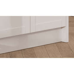 Close-up of a wooden floor with a white plinth