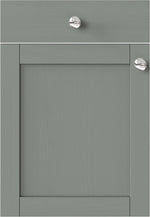 Waterford Sage Green kitchen cabinet door with two silver knobs.