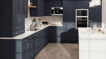 Modern kitchen with dark blue cabinets and white countertops